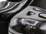 a close up of a pair of black shoes on a table
