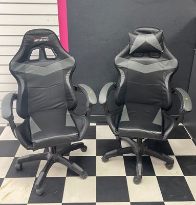 two black and gray racing chairs sitting on a checkered floor