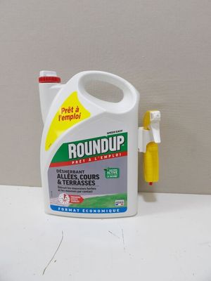 a bottle of groundup next to a toothbrush on a table