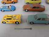 several toy cars are lined up on a table with a nail