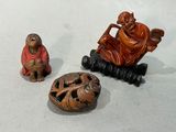 trois figurines représentant un homme et un singe assis sur un banc