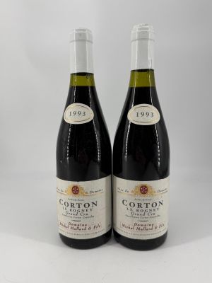 two bottles of red wine sitting next to each other on a white surface