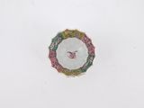 a white plate with a pink and green design on it