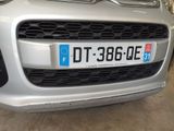 a silver car that is parked in a garage