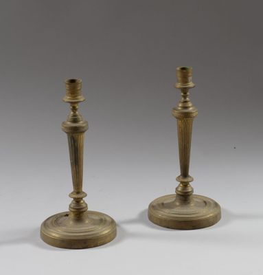 pair of antique brass candlesticks on a white background