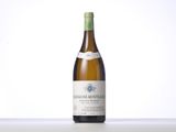 a bottle of white wine sitting on top of a table