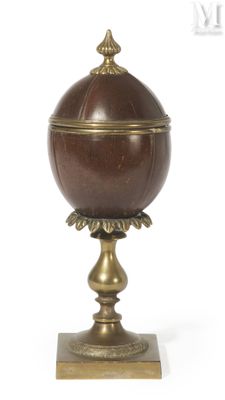 an image of a brown and gold urn on a wooden base
