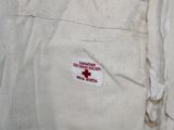 a white uniform with a red cross patch on it