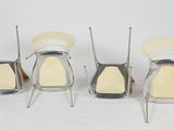 four chairs that are sitting on a white surface