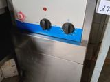 an image of a stainless steel stove with a blue and white stripe