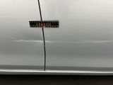 a close up of a car door with a sticker on it