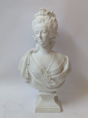 a white bust of a woman with a necklace on it