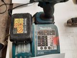a drill and a cordless drill sitting on a table