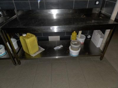 a black counter with two buckets and a yellow container