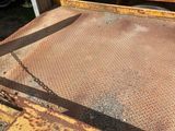 a rusted bed in front of a sign that says john dog