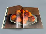 a book with a picture of a plate of oranges on it