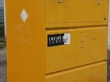 a yellow box with a sign on it sitting in the dirt