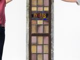 they are standing in front of a stained glass window with the word reis written on it