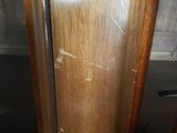 an image of a wooden cabinet with a broken glass door