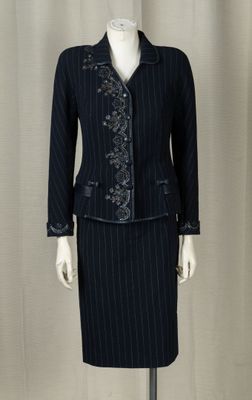 a mannequin dressed woman wearing a skirt suit and jacket