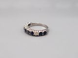 a white gold ring with blue sapphires and diamonds