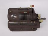 a close up of an old type of machine on a white surface