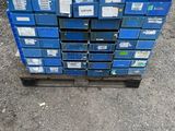 a stack of blue crates sitting on top of a wooden pallet