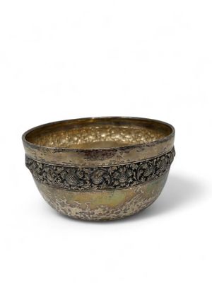 a close up of a metal bowl on a white surface