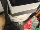 a pile of garbage sitting on the floor next to a cooler
