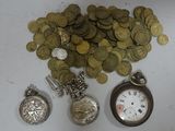 a lot of coins and a pocket watch on the table