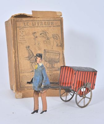 a toy of a man standing next to a box with a cart