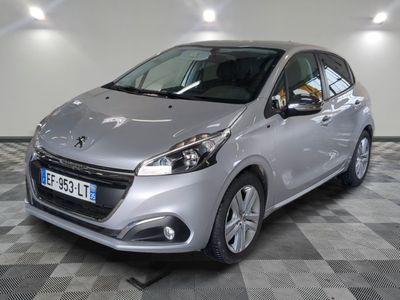 the small silver car is parked in a large room