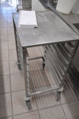 a metal table with a book on it in a kitchen