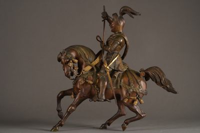 statue of a man riding a horse with a spear on its back