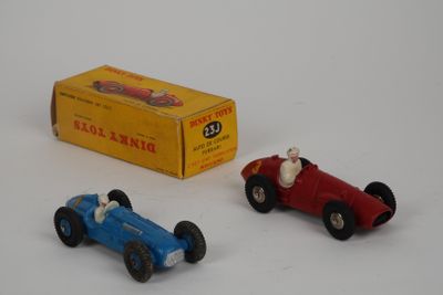two toy cars sitting next to each other on a table