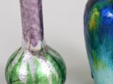 two vases sitting next to each other on a table