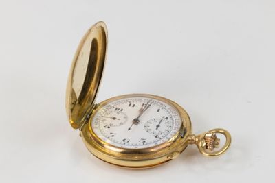 a gold pocket watch sitting on a white surface