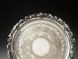 a silver plate with a circular design on the rim