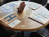 tables and chairs in a restaurant with a view of the street