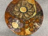 a brown plate with a flower on it sitting on a table
