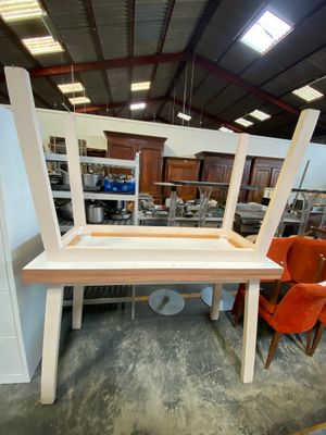 a table with a chair on top of it in a room