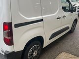 the white van is parked on the side of the road