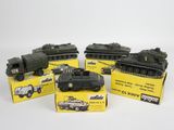 six véhicules militaires miniatures sont alignés dans des boîtes sur une surface blanche
