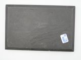 a piece of black slate with a sticker on it