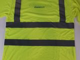 a close up of a yellow shirt with reflective stripes on it