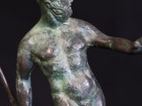 bronze statue of a man holding a spear and a shield