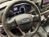 the interior of a car with a steering wheel and dashboard controls
