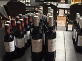 bottles of wine are lined up on a table in a wine shop