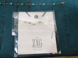 a picture of a necklace and a bracelet on a table