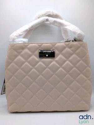 a white purse with a white handle and a white handle